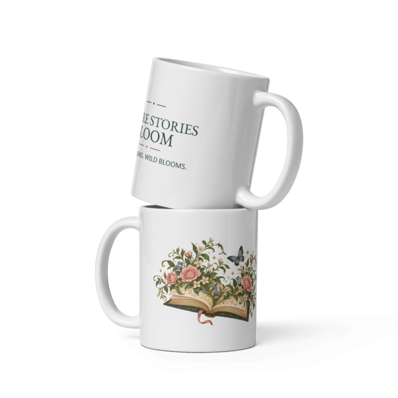 two white ceramic mugs stacked, one showing the Where Stories Bloom illustration and one showing the printed lettering