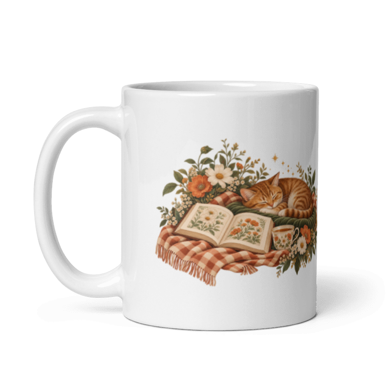 white glossy 11 oz ceramic mug with the A Sunday Well Read sleeping cat and open book illustration, handle on the left